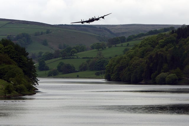 DERWENT, UNITED KINGDOM - MAY 16:  A Lancaster bomber flies over Ladybower reservoir in the Derbyshire Peak District to mark the 65th anniversary of the World War II Dambusters mission on May 16, 2007 in Derwent, England. Ladybower and Derwent reservoirs were used by the RAF's 617 Squadron in 1943 to test Sir Barnes Wallis'  bouncing bomb before their mission to destroy dams in Germany's Ruhr Valley.  (Photo by Christopher Furlong/Getty Images)