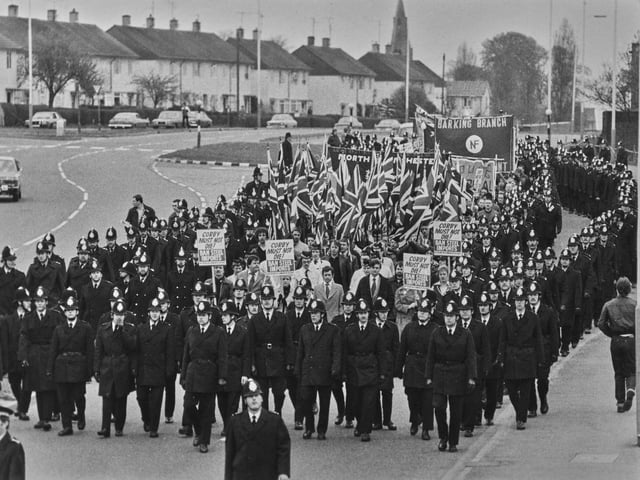 Police officers form a cordon alongside a march by the National Front (NF), a British far-right fascist political party, Corby, Northamptonshire, April 1980. (Photo by Keystone/Hulton Archive/Getty Images)