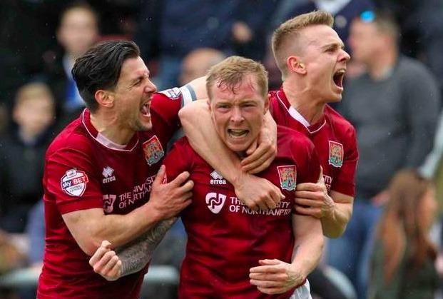 Sam Hoskins celebrates with Nicky Adams and David Buchanan as Cobblers draw 2-2 with Bristol Rovers to secure promotion. Hoskins scored Town's second and the goal that ultimately clinched promotion.