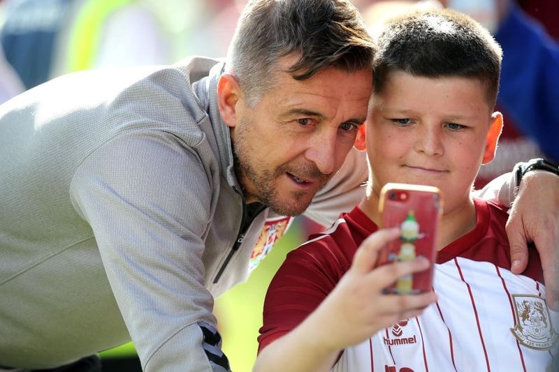 Northampton Town manager Jon Brady has a selfie taken by a young fan at the end of the Sky Bet League Two between Crewe Alexandra and Northampton Town on August 20, 2022.