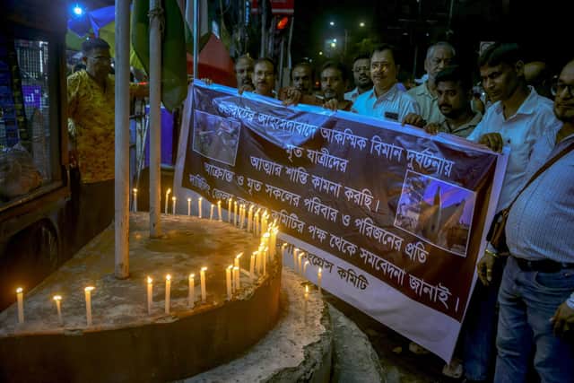 Indian congress party supporters light candles as they pay homage to the victims of Air India flight 171 which crashed in a residential area near the Ahmedabad airport, in Siliguri, India on June 12, 2025.