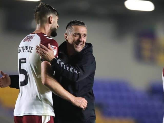 Skipper Jon Guthrie and manager Jon Brady celebrate Tuesday night's win at AFC Wimbledon (Picture: Pete Norton)