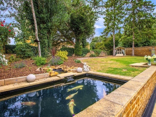 This modern family home is in a picturesque village and shares its boundary with a church.