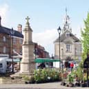 Brackley Town Centre with greenery around a church in the background