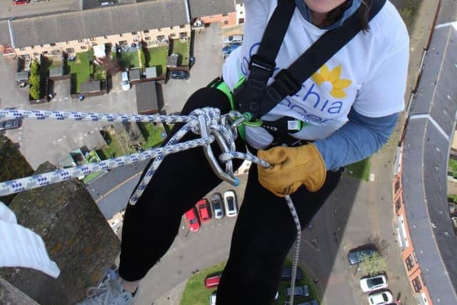 1)	Mandy Colby from Commsave abseiling down Northampton Lift Tower.