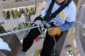 1)	Mandy Colby from Commsave abseiling down Northampton Lift Tower.
