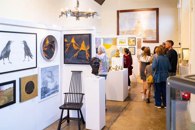 Visitors enjoying the artwork on display at one of last years' exhibitions.