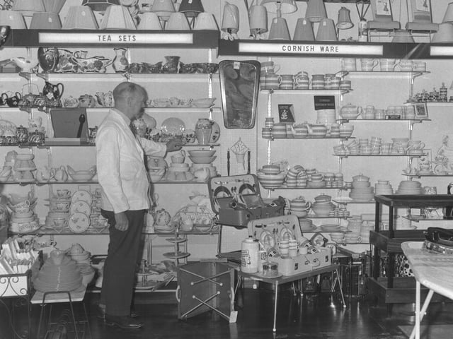 Looking Backold glass negsJuly 31, 1962Barnwell LtdMan with selection of China, including Cornish ware