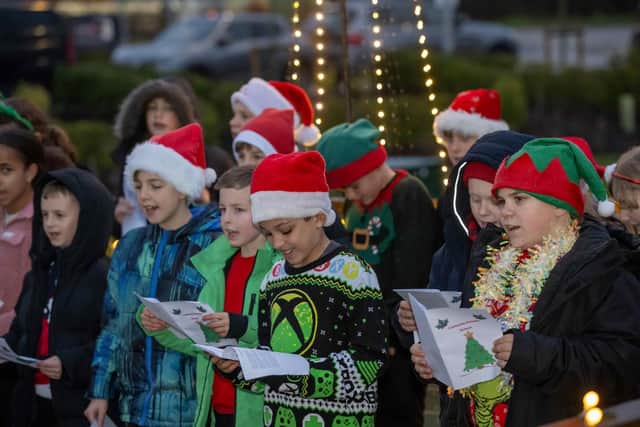 Year six pupils from Loatlands Primary School performing carols on decking outside the sales centre at the development.