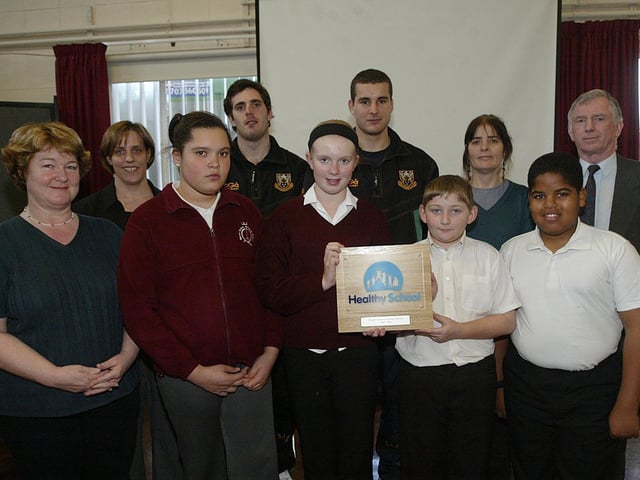 2007: Queen Eleanor Primary School receiving a National Healthy Schools Award. Pictured: Karen Graystone, head, Charlie Ward, Healthy Schools co-ordinator, Jon Clarke, Saints player, Mark Easter, Saints player, Liz Cundy, Healthy Schools advisor and Fred Watson, chair of Governors, with year six school council members receiving the National Healthy Schools Award.