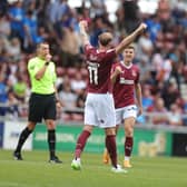 Mitch Pinnock celebrates as the referee blows his full-time whistle to confirm a first Cobblers victory over Posh in 17 years. Picture: Pete Norton.