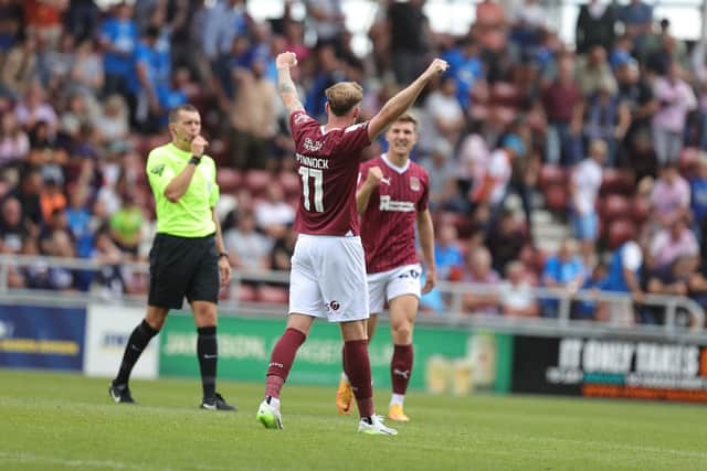 Mitch Pinnock celebrates as the referee blows his full-time whistle to confirm a first Cobblers victory over Posh in 17 years. Picture: Pete Norton.