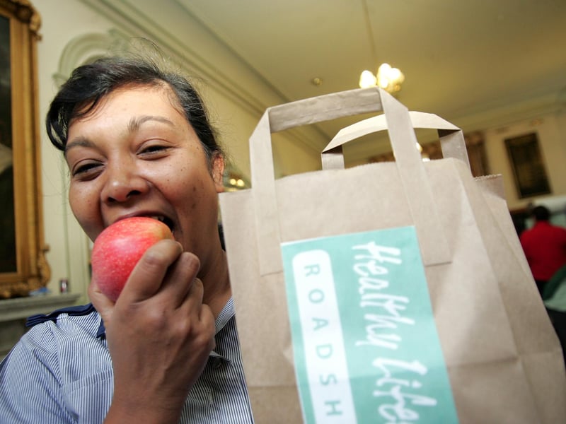 Healthy Roadshow at Northampton General Hospital. Set up by the PCT and Northampton Council for Hospital staff. Nurse Lystra Cunningham tucking into an apple from her free gift bag in September 2006