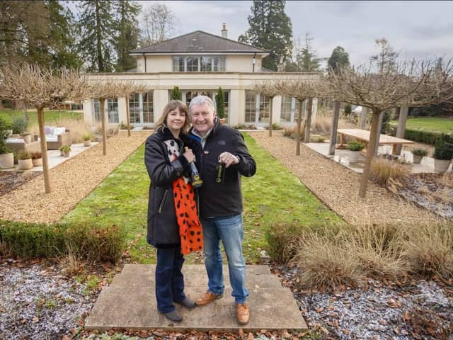 Winner Michael with his wife, Amanda, outside their new home. Picture: Omaze