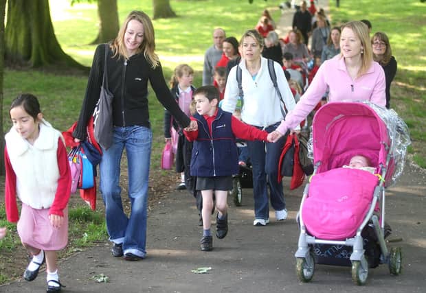 Cedar Road Primary School pupils, parents and staff walking from Abington Park playground to school as part of 'Walk To School' week.