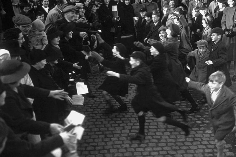 Happy evacuee children rush to greet their parents off the special London Midland and Scottish train in Northampton as part of a scheme to reunite families on 3rd December 1939: