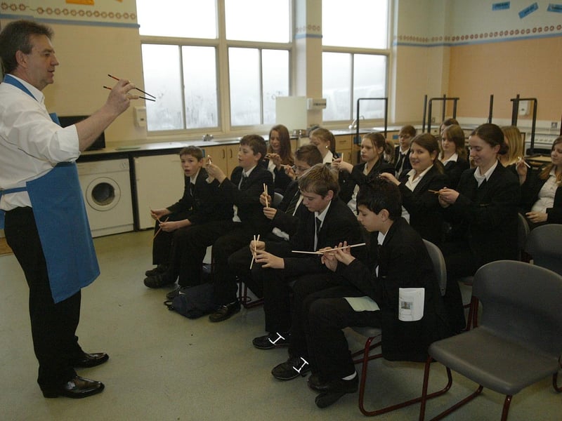 International Day for year 8 pupils at Campion School. Pictured: David Pope, French and PE teacher, teaching pupils how to use chopsticks in a Chinese cookery class.