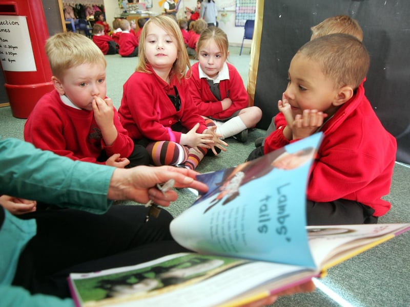 Teaching assistant Sue Dewsnap at Cedar Road Primary School, reads to the children and also how to ride bikes