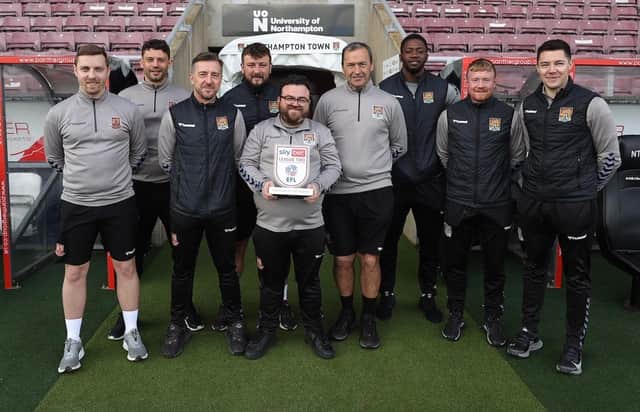 Jon Brady and the backroom staff with the League Two Manager of the Month trophy