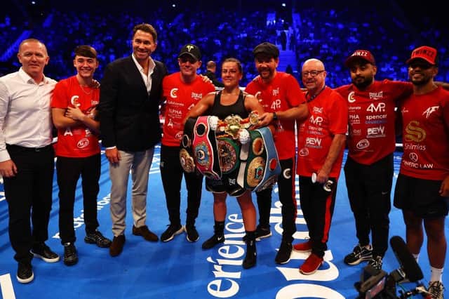 Chantelle Cameron and her team celebrate after claiming the IBF, IBO, WBA, WBC and WBO world title belts on Saturday night
