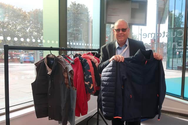 Councillor Last donates a coat to the coat rack