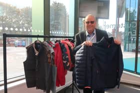 Councillor Last donates a coat to the coat rack