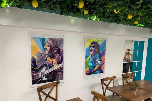 The seating area is decorated with colourful paintings and has a modern feel, while the artificial lemon tree decorations give it an extra special touch