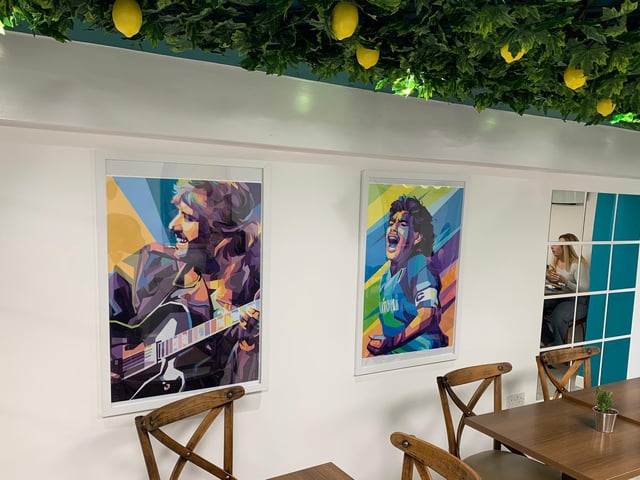 The seating area is decorated with colourful paintings and has a modern feel, while the artificial lemon tree decorations give it an extra special touch