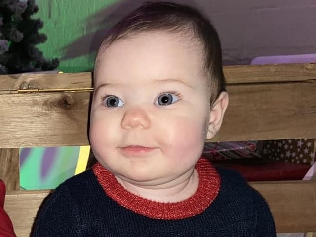 Ayla Mae dressed in a festive outfit for her first Christmas.