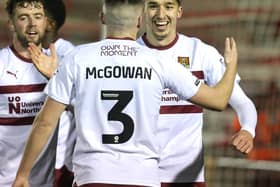 Kieron Bowie and Aaron McGowan high five after Cobblers double their lead at Lincoln with a sensational counter-attacking goal.