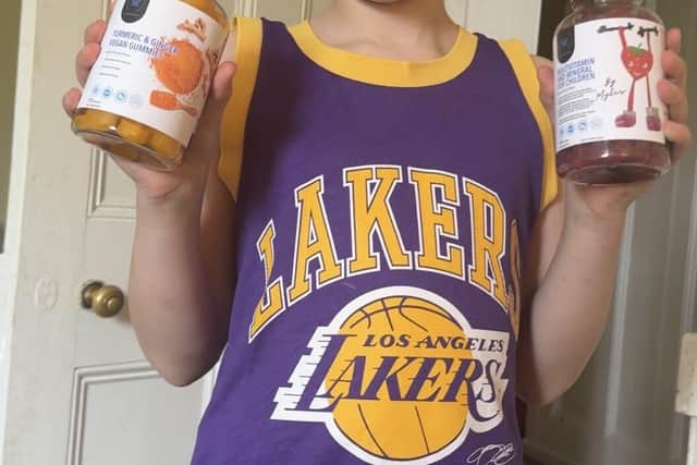 Myles holding his vitamins