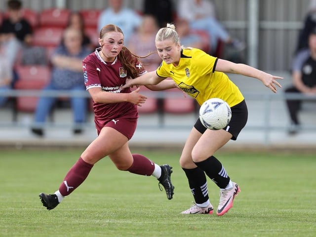 Georgia Gale and Summer Reece battle for the ball