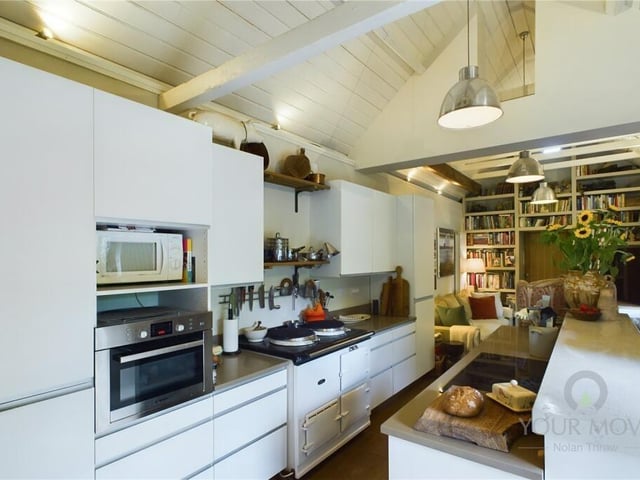 The kitchen boasts plenty of bench space and leads to a dining area