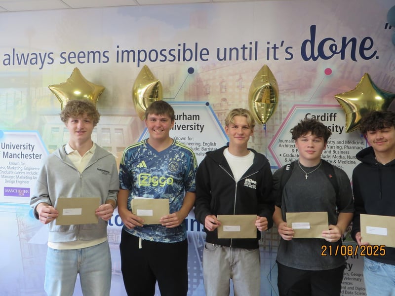 Year 11s pick up their envelopes to reveal their results.
