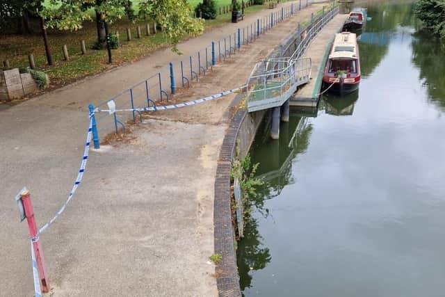 Parts of the river footpath are cordoned off by police.