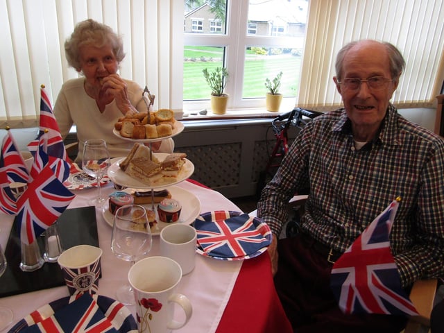 Two residents Gillian and Tony enjoying their Coronation Day Afternoon Tea