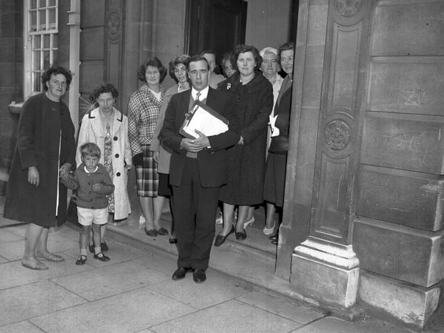 People gathered in doorway, location and date unknown