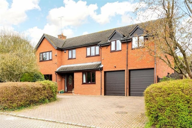 The property makes a striking first impression, with a sweeping driveway and double garage