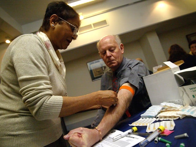 Northampton Museum taking blood from volunteers for local blood mapping / gene tables of the local area. Pictured is Tony Palmer having his blood taken by Tammy Day
