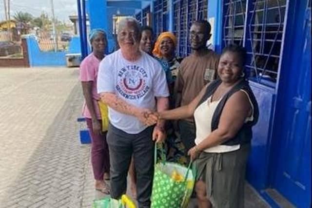 Eunice pictured with a donations with a Ghanian head teacher