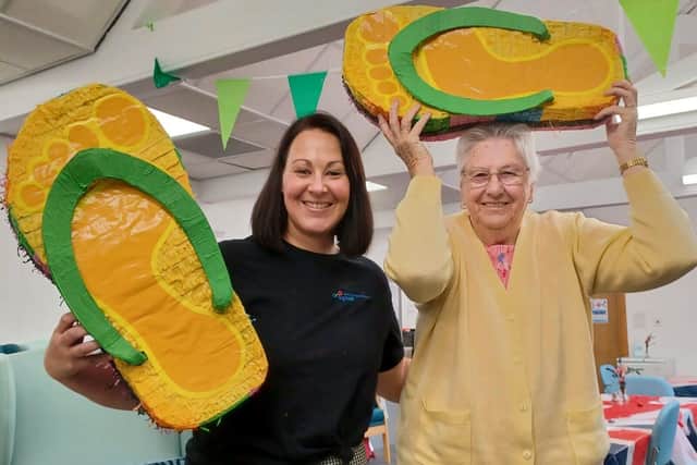 Senior Coordinator Amey with Ruth and the piñata flip-flops
