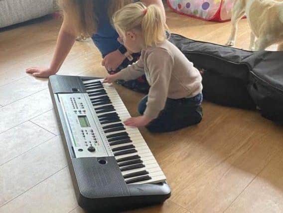 A music therapist from Thomas's Fund working with a young patient.
