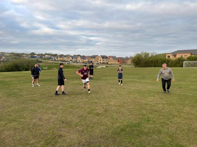 Residents enjoying the new football pitch at Glenvale Park