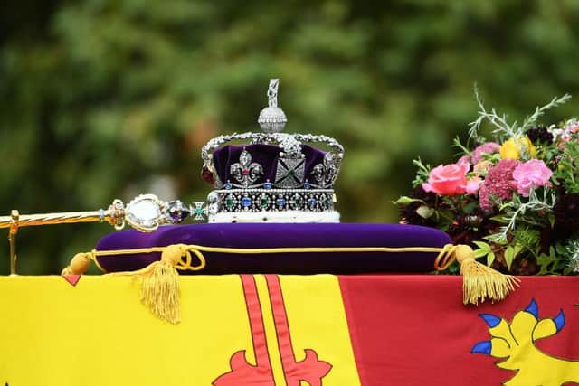LONDON, ENGLAND - SEPTEMBER 19: The coffin of Queen Elizabeth II with the Imperial State Crown resting on top is carried by the Bearer Party as it departs Westminster Abbey during the State Funeral of Queen Elizabeth II on September 19, 2022 in London, England.  (Photo by Joe Maher/Getty Images)