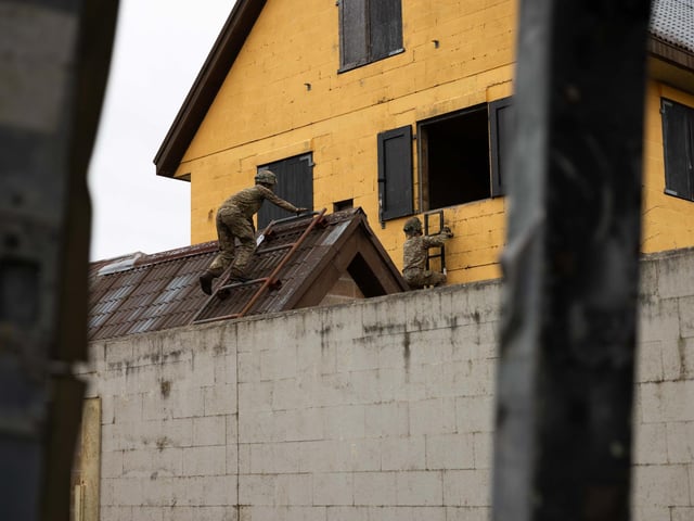 Soldiers from 2nd Battalion The Royal Anglian Regiment climb the final obstacle into a house during their run through the Confidence Course in Copehill Down.This is part of the Regiment's  build up training ahead of their deployment onto Exercise Wessex Storm.