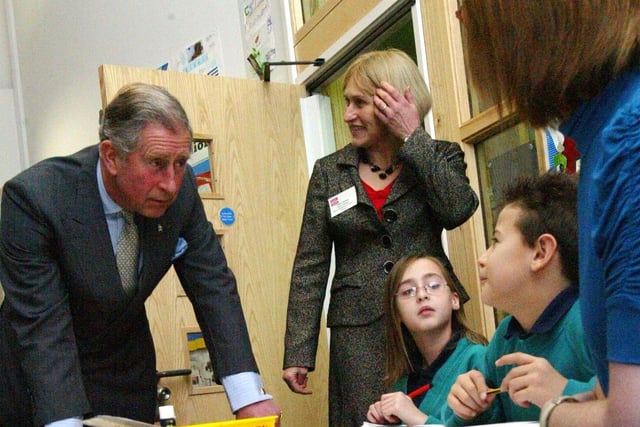 Prince Charles talks to children during a lesson at Upton Meadows Primary School