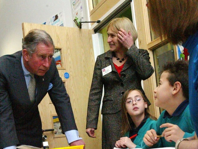 Prince Charles talks to children during a lesson at Upton Meadows Primary School