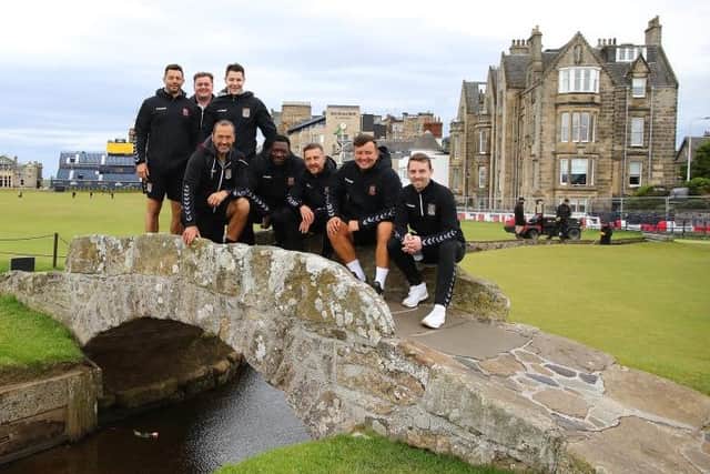 The Cobblers management and coaching team pose for a picture on the Swilcan Bridge on the Old Course at St Andrews Links golf course