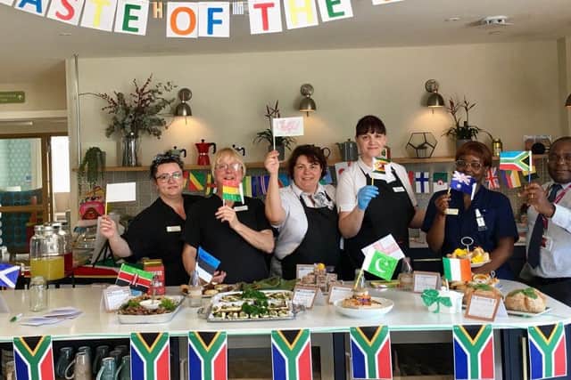 Staff at Brackley Care Home wave their flags in anticipation of the event