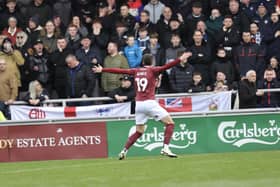 Kieron Bowie celebrates in front of the Bolton fans after giving Cobblers a very early lead at Sixfields.